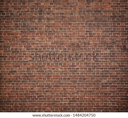 Full frame image of the old red brick wall. High resolution texture with vignetted corners for background, poster, collage in the vintage, loft or grunge style