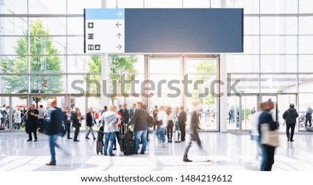 Crowd of business people walking at a airport, with banner and copy space for individual text