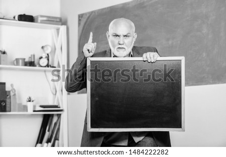 bear in mind. exam and graduation results. information is here. senior man teacher with empty blackboard. place for copy space. Mature teacher man hold chalk board. back to school. Education concept.