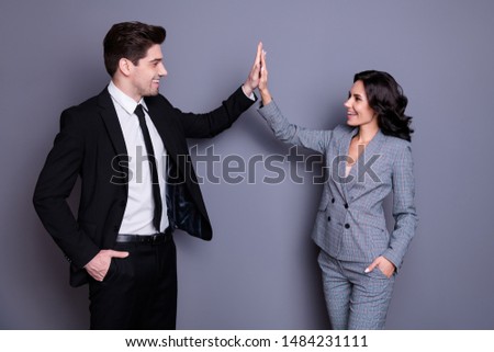 Profile side photo of  cheerful businesspeople with wavy curly brunet hairstyle giving high five wearing black jacket blazer isolated over gray background
