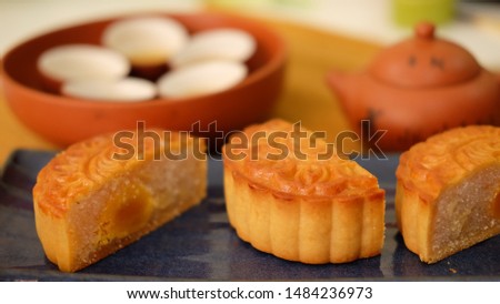 half moon cakes with tea set in warm color tone