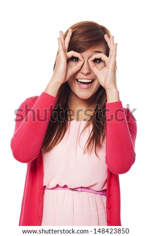 Happy young woman making hand gesture