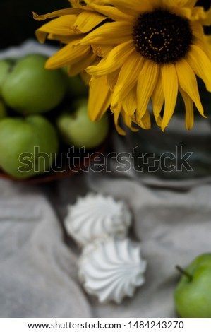 Composition with marshmallows, sunflowers and apples, selective focus