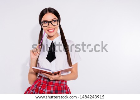 Close-up portrait of her she nice attractive lovely winsome charming cute cheerful cheery curious girl holding in hands diary doing home work task isolated over light white background