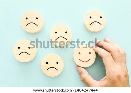 Business concept photo of chosen person among others. a smiling face stands out from the crowd
