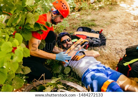 Search and rescue team helping injured  bicyclist