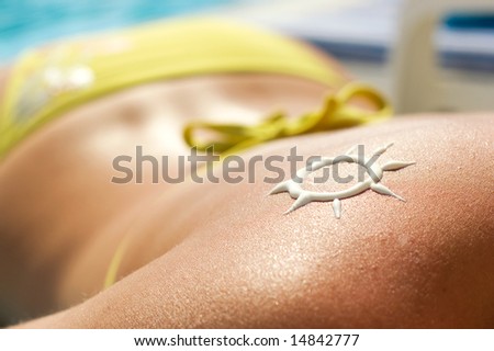 A sun made with suncream at the shoulder (shallow dof) Royalty-Free Stock Photo #14842777