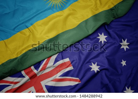 waving colorful flag of australia and national flag of rwanda. macro