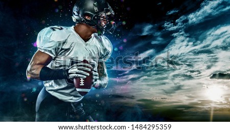 American football sportsman player on stadium running in action. Sport wallpaper with copyspace.