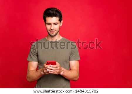 Closeup photo of amazing guy looking interested telephone casual outfit isolated on bright red background