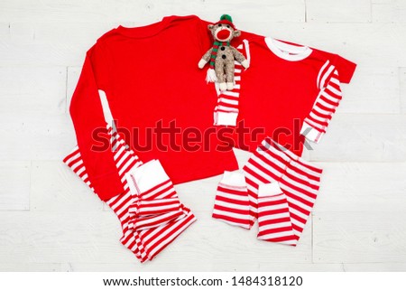 Blank red siblings christmas pajamas with monkey stuffie on white background, christmas family apparel mockup