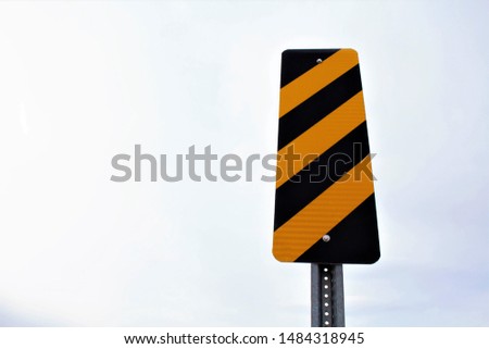 Black and yellow stripes on sign post Royalty-Free Stock Photo #1484318945