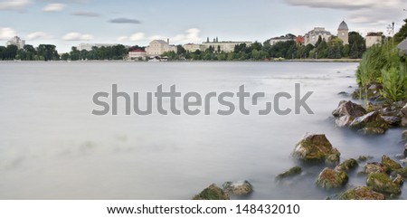 View of the sky and stones in wind weather on a lake