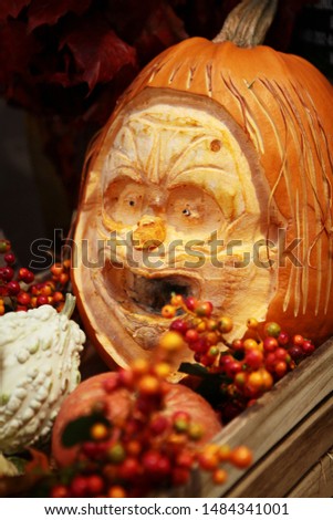 Pumpkin, with a carved face of a man for the holiday of Halloween. Vegetables for the feast of all saints. Photo in the interior.
