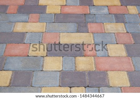 Multi color Paving stone, background. Pedestrian zone in the park in daylight. Urban varicoloured walkway.