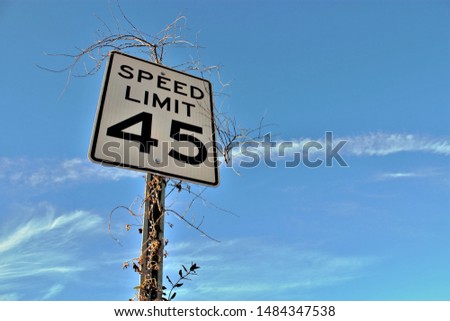 Speed limit 45 with blue sky and clouds Royalty-Free Stock Photo #1484347538