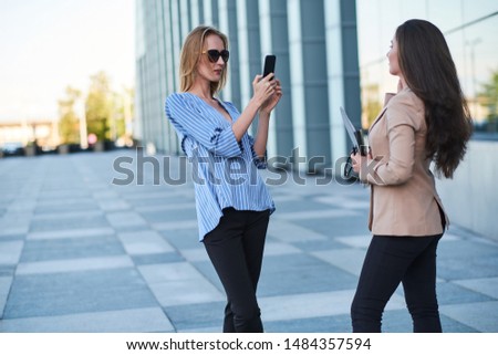 Curious journalist is taking interview from successful businesswoman on the street.