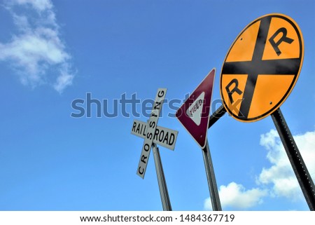 Railroad crossing with yield sign Royalty-Free Stock Photo #1484367719