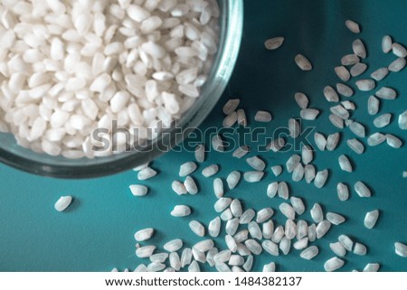 Rice in a bowl over blue background
