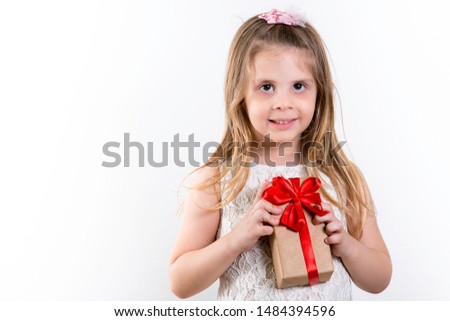 Cute Girl, Girl holding gift with red bow on Children's Day. White Background, copy space.