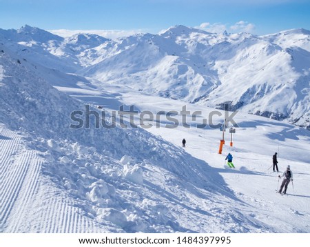 France, Meribel valley: Panoramic landscape view down valley with ski slope piste in winter alpine mountain resort Royalty-Free Stock Photo #1484397995