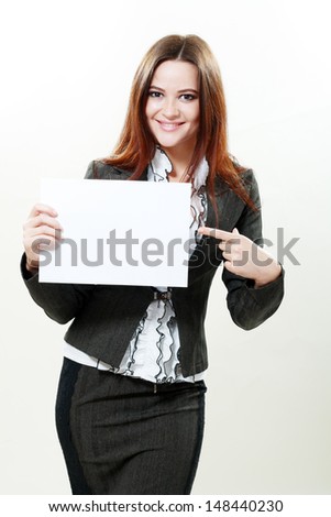 A beautiful woman holds out an empty card studio shot