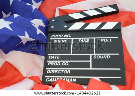 A movie clapboard and American flag for representing the American made film industry.