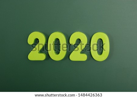 2020 year written in bright plastic magnetic letters stuck on a magnetic board