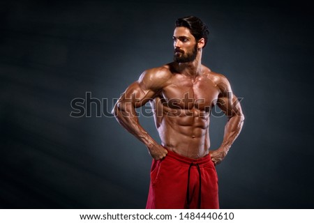 Handsome Muscular Men Posing and Flexing Muscles Royalty-Free Stock Photo #1484440610