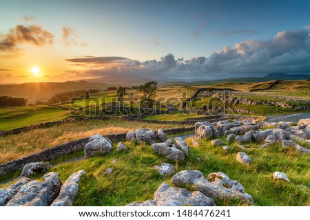 Dramatic sunset over beautiful scenery at the Winskill Stones near Settle in the Yorkshire Dales Royalty-Free Stock Photo #1484476241