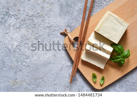 Classic tofu cheese on a wooden board. Soy cheese. View from above.