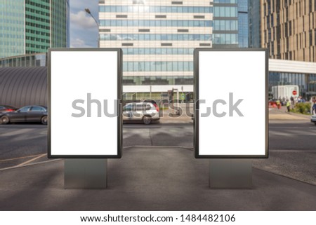 Two blank street billboard poster stands mock up on city business district background. 