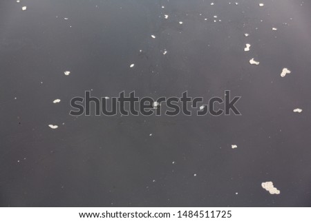 Foam and bubbles floating on the surface of deep water on an overcast day.