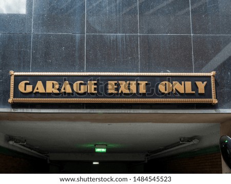 Gold and Black Garage Exit sign