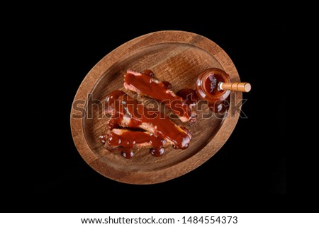 Barbecue sauce ribs on rustic cutting board