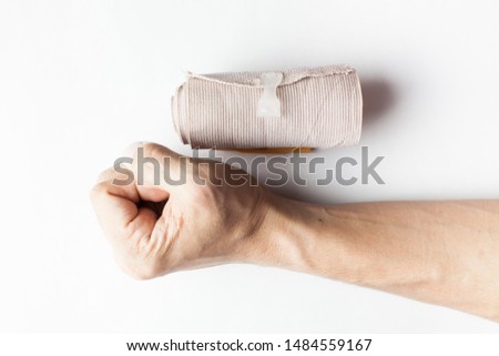 Hand and elastic bandage isolated on white background. Help perevent and heal wrist pain, reduce muscle pain and recover common injury  Royalty-Free Stock Photo #1484559167