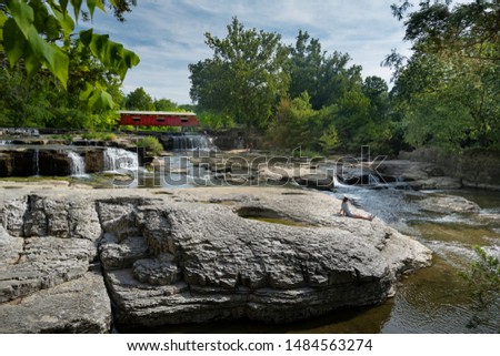 Enjoying the day at Cataract Falls covered bridge on Mill Creek Owen County, Indiana