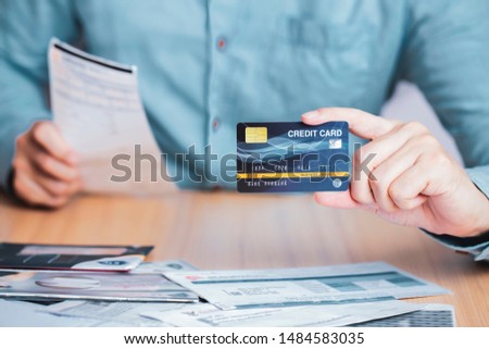 Businessman payment bill receipt with credit card , business e-commerce to pay credit card debt concept