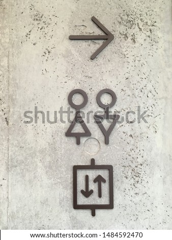 Sign of toilet,exit door and elevator