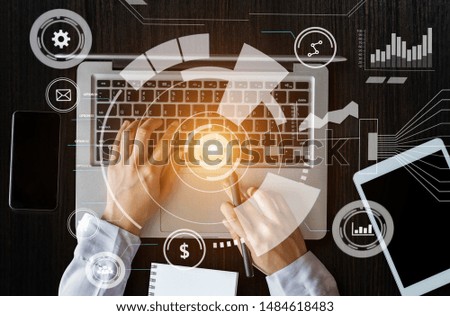 Businesswoman hand working digital marketing media in virtual screen with mobile phone and modern compute with VR icon diagram at office in morning light 
