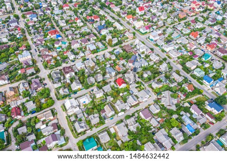 aerial view of suburb area in summer with green trees and lots of houses