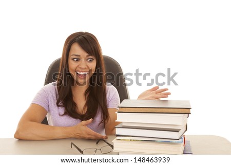 A woman with a surprised expression looking at her stack of books.