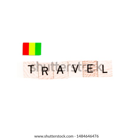 The Flag of Guinea and "TRAVEL" Wooden Block Letters