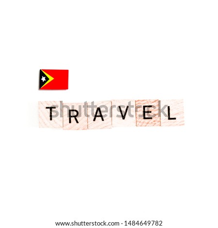 The Flag of East Timor and "TRAVEL" Wooden Block Letters