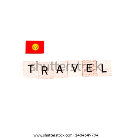 The Flag of Kyrgyzstan and "TRAVEL" Wooden Block Letters