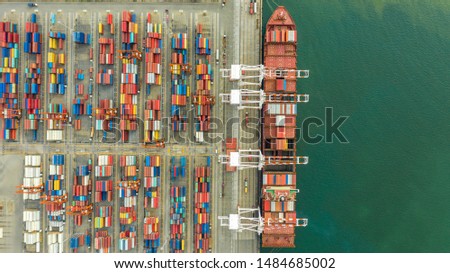 Container ship in export and import business and logistics. Shipping cargo to harbor by crane.