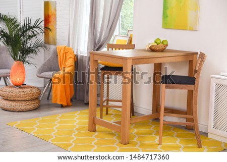 Modern dining room interior with wooden table and chairs