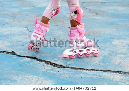 Legs of girls playing Roller Blade Skate or In-line Skate on cement floors.