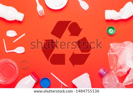 Plastic waste collection on a red background. Concept stop plastic recycling garbage. Flat lay, top view