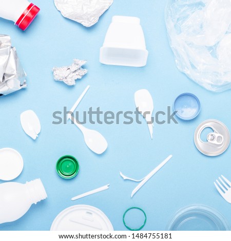 Garbage collection, plastic and metal on a blue background. Concept stop plastic, recycling, separate collection of garbage. Flat lay, top view